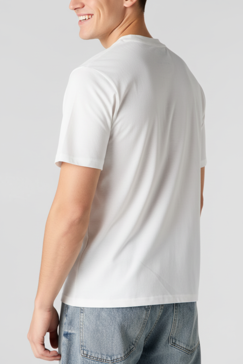 A man viewed from the back wearing a plain white short-sleeve crewneck t-shirt and light blue denim jeans against a light gray studio background.